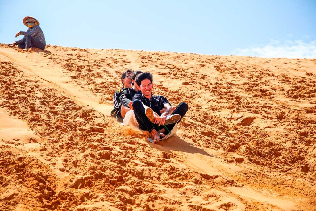 sand-surfing or zansailing the red sand dunes in Mui Ne